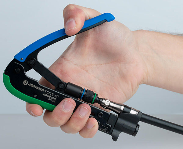 Dual Compression Tool - Short and Long Style F Connectors - Hand held close up of tool compressing cable - Primus Cable