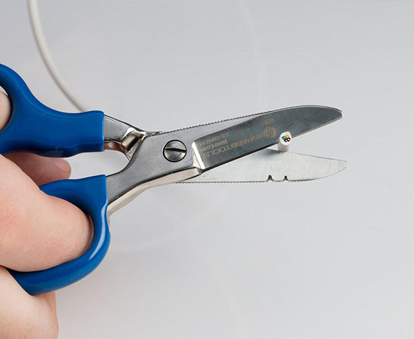 Ergonomic Electrician's Scissors - Scissors cutting white wire - Primus Cable