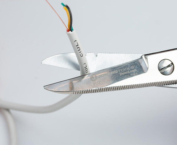 Electrician's Scissors - White cable being trimmed with scissors - Primus Cable