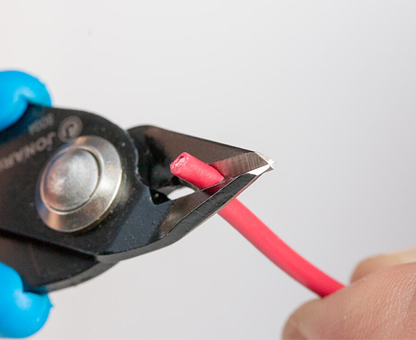 Flush Cut Pliers - Pliers in use cutting red cable - Primus Cable