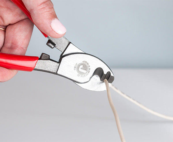 Copper COAX & Network Cable Cutter - Cutter in use on white cord - Primus Cable