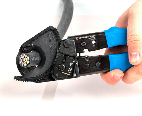 Ratcheting Cable Cutter, 500 MCM - Hand holding cable cutter while cutting black cable - Primus Cable