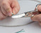 Splicer's Kit - Electricians scissors in use with white cable - Primus Cable 