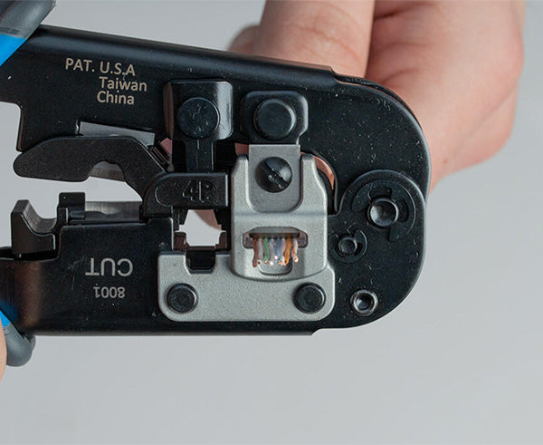 6-in-1 Crimping Tool, RJ45 Pass-through & RJ11/12 Modular - Close up of tool at work - Primus Cable