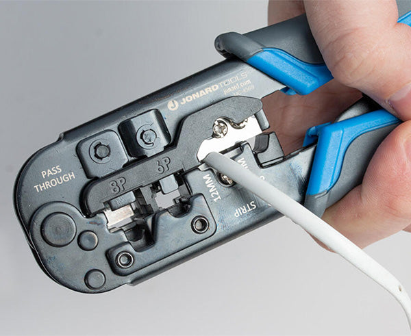 6-in-1 Crimping Tool, RJ45 Pass-through & RJ11/12 Modular - In use on white cable crimping - Primus Cable