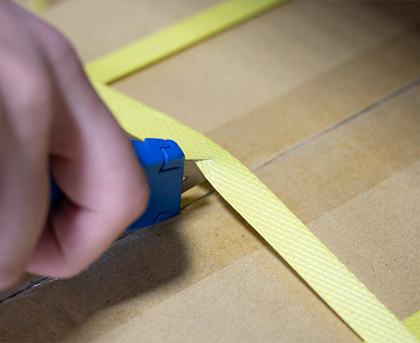 Heavy Duty Utility Knife - In use cutting packaging ribbon - Primus Cable