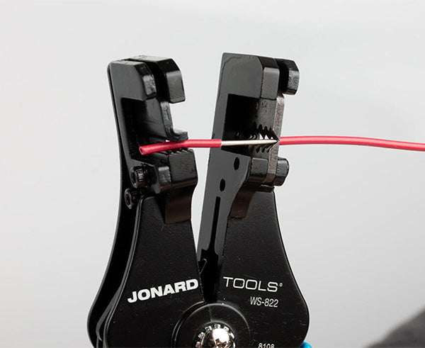 Wire Stripper and Cutter, 8-22 AWG - In use stripping red jacket from wire - Primus Cable